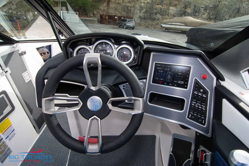Slide: The Image of 2024 MasterCraft X22 boat dashboard with steering wheel and control panel. - 28