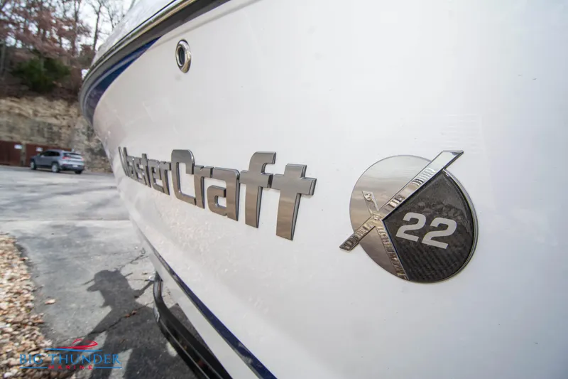 Slide: The Image of 2024 MasterCraft X22 boat side view with logo and model emblem. - 3