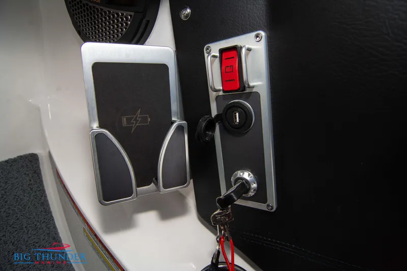 Slide: The Image of 2024 MasterCraft X22 boat ignition panel with key and control switches. - 31