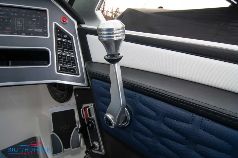 Slide: The Image of 2024 MasterCraft X22 boat interior control panel and throttle lever. - 32