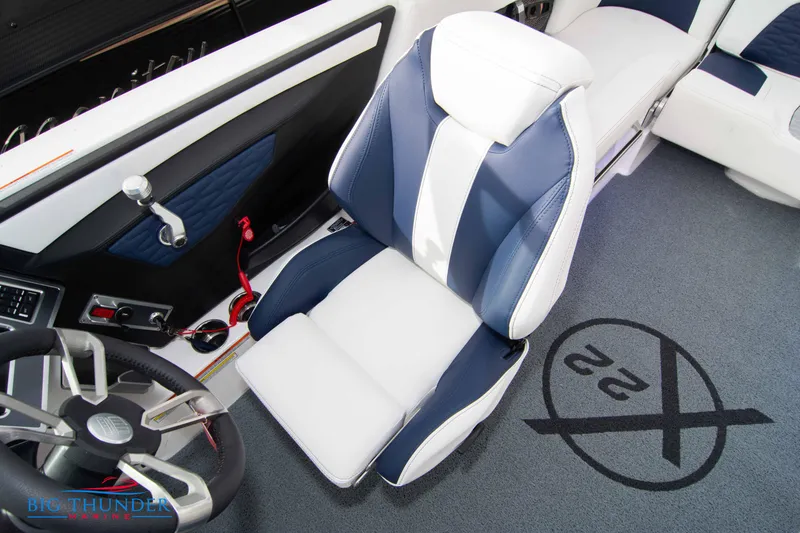 Slide: The Image of 2024 MasterCraft X22 boat interior with captain's chair and steering wheel. - 35