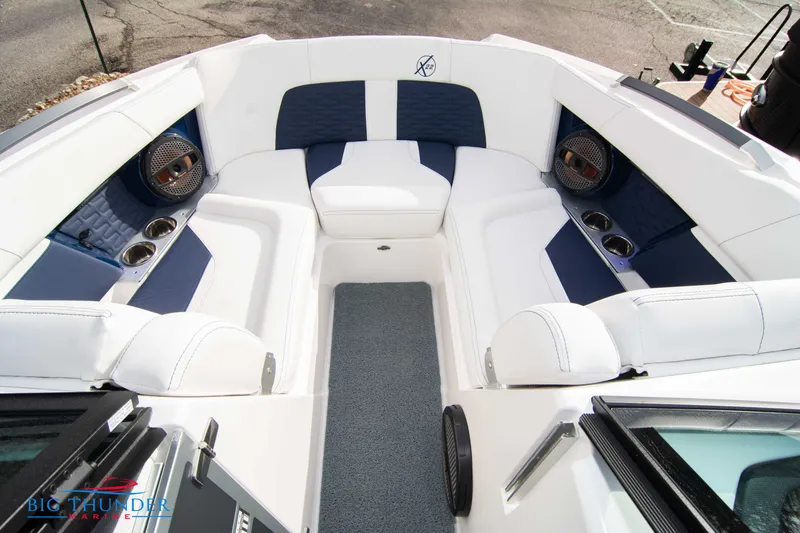 Slide: The Image of 2024 MasterCraft X22 boat interior with white and blue seating. - 40