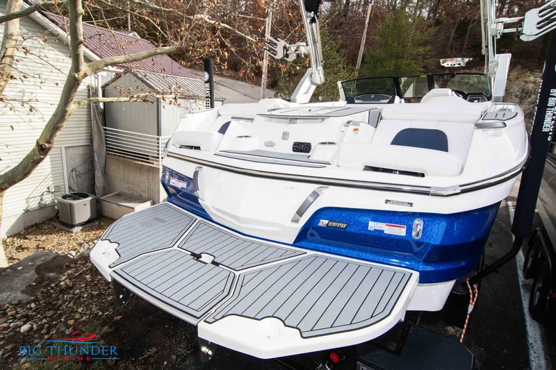 Slide: The Image of 2024 MasterCraft X22 boat with swim platform and blue hull. - 7