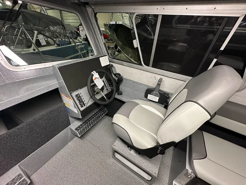 Slide: The Image of 2024 KingFisher 2325 Coastal Express boat interior with steering wheel and captain's seat. - 13