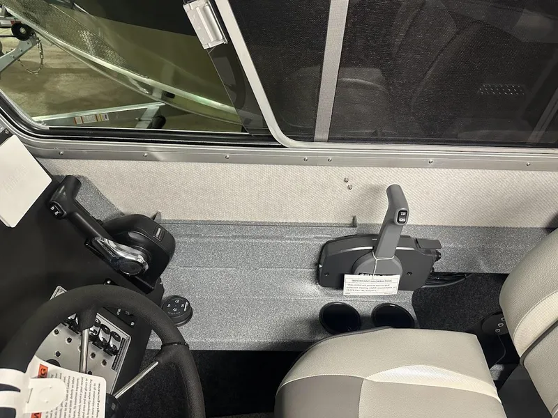 Slide: The Image of 2024 KingFisher 2325 Coastal Express interior cockpit with steering wheel and controls. - 15