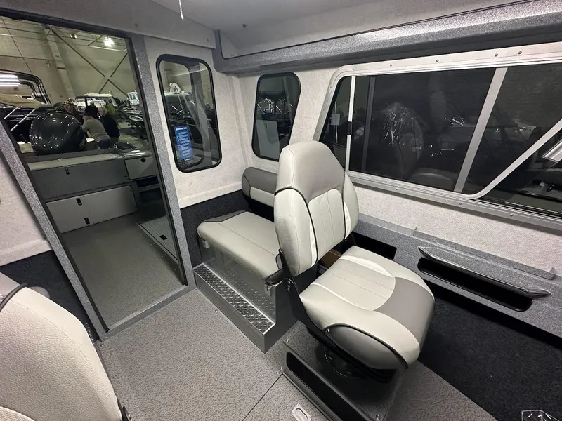 Slide: The Image of 2024 KingFisher 2325 Coastal Express interior cabin with seating and windows. - 17