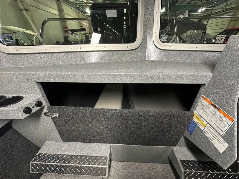 Slide: The Image of 2024 KingFisher 2325 Coastal Express interior storage compartment with diamond plate steps. - 18