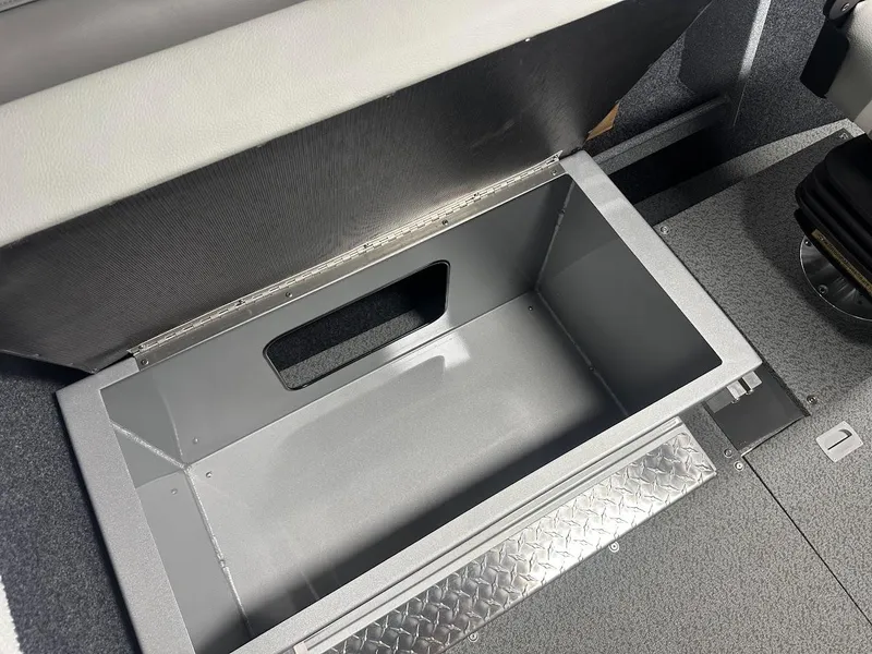 Slide: The Image of KingFisher 2325 Coastal Express 2024 under-seat storage compartment, open and empty. - 23