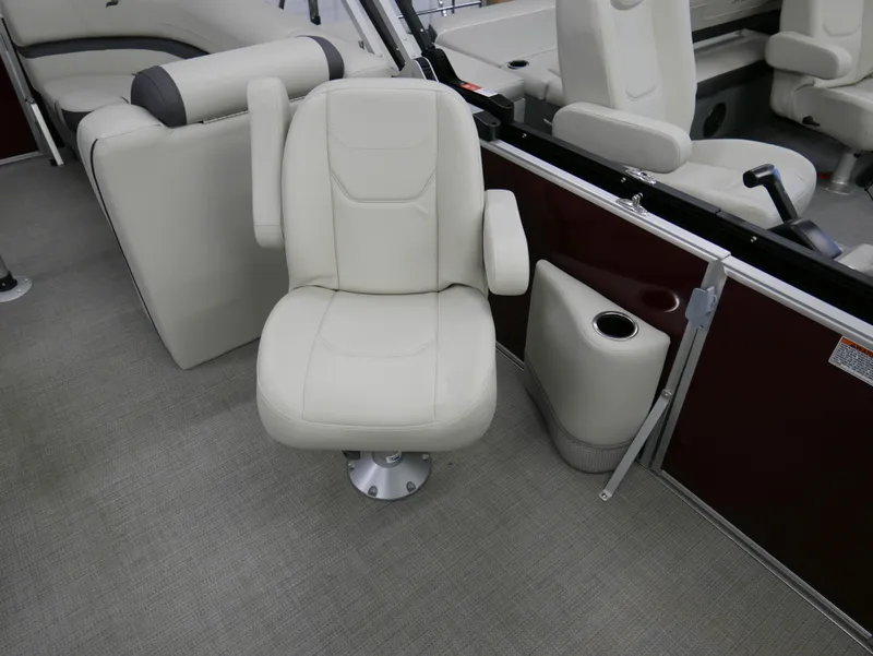 Slide: The Image of 2024 Starcraft EX 22 R boat interior with plush seating and cup holder. - 11