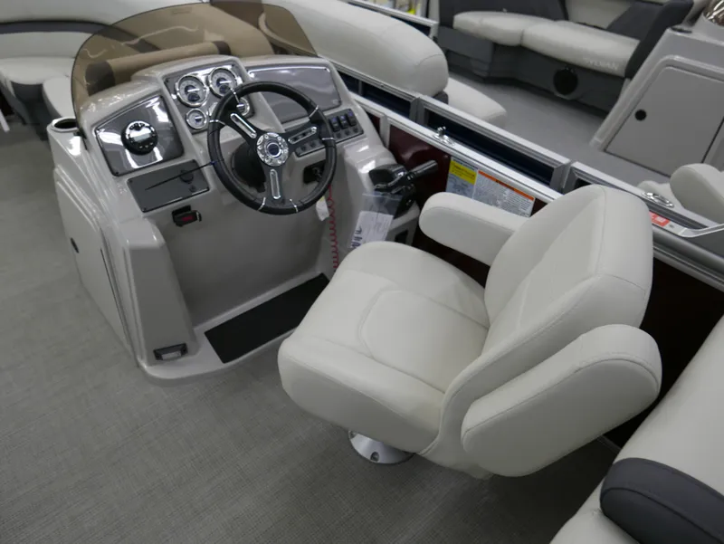 Slide: The Image of 2024 Starcraft EX 22 R boat interior with steering console and comfortable seating. - 13