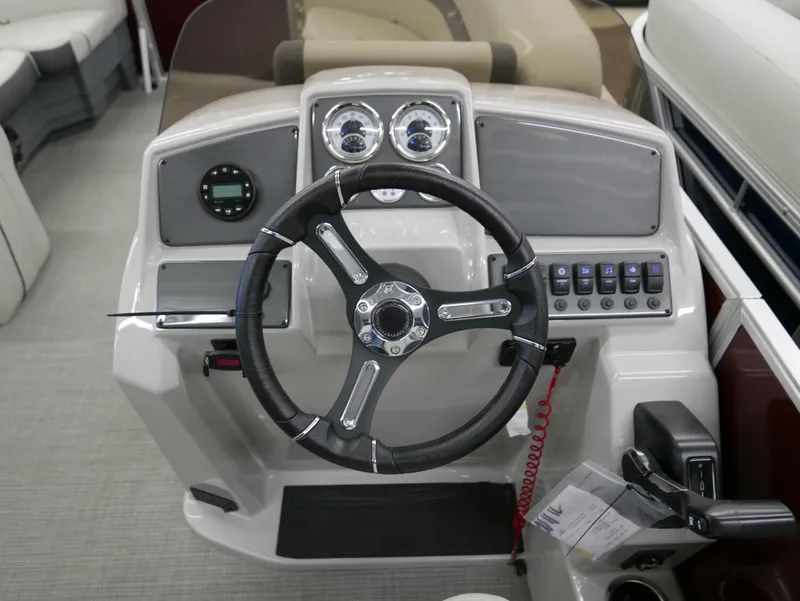 Slide: The Image of 2024 Starcraft EX 22 R boat dashboard with steering wheel and control panel. - 14