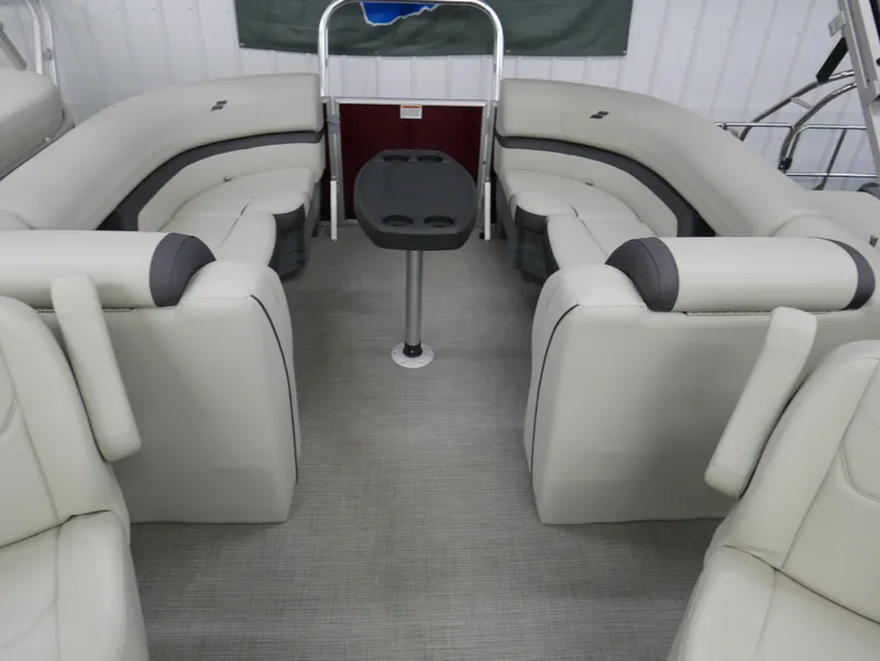 Slide: The Image of 2024 Starcraft EX 22 R boat interior with beige seating and central table. - 16