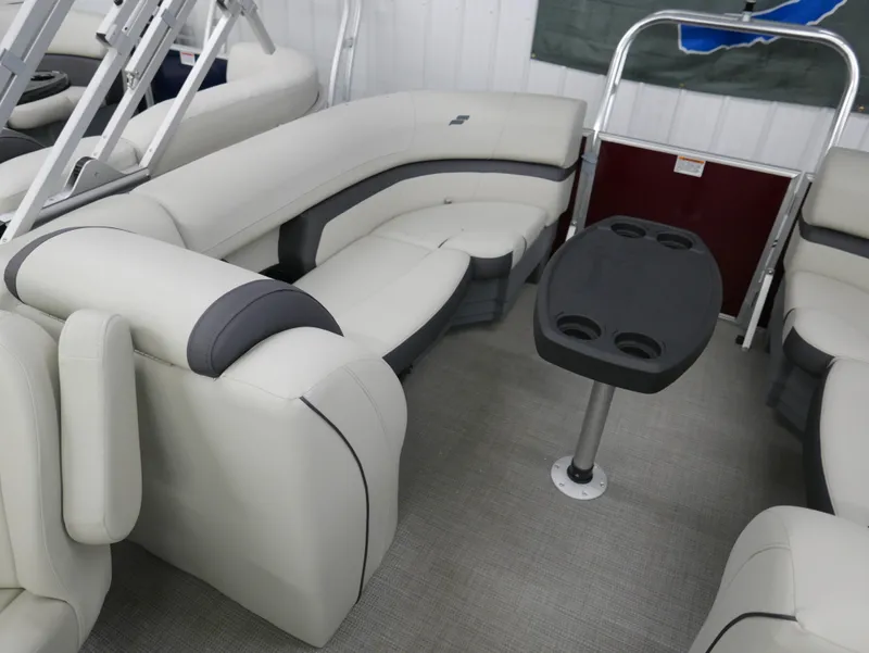 Slide: The Image of 2024 Starcraft EX 22 R boat interior with plush seating and table. - 18