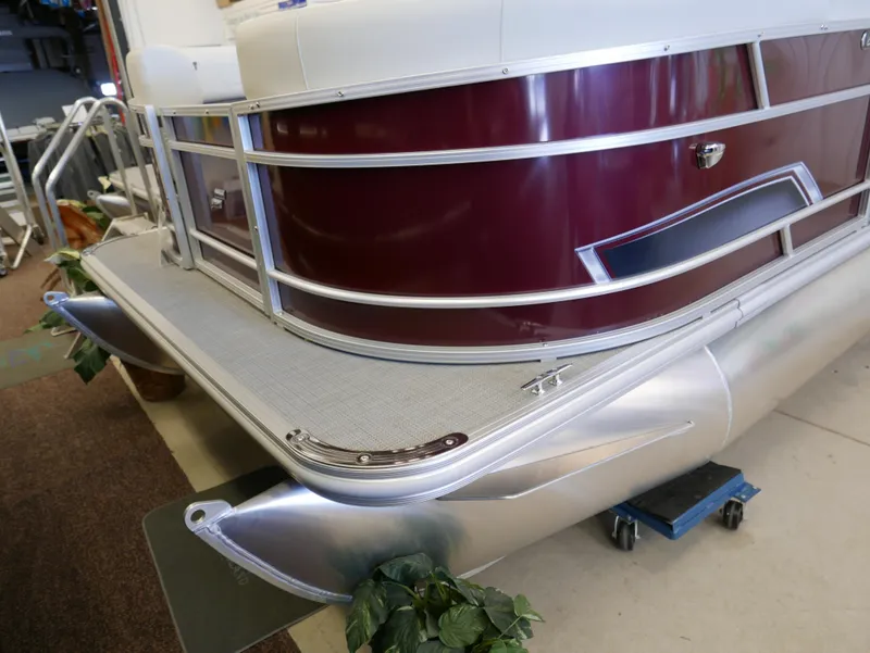 Slide: The Image of 2024 Starcraft EX 22 R pontoon boat with maroon exterior and silver trim. - 3
