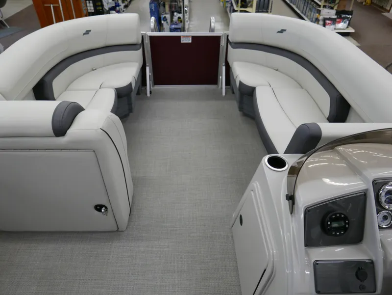 Slide: The Image of 2024 Starcraft EX 22 R pontoon boat interior with plush seating and modern dashboard. - 4