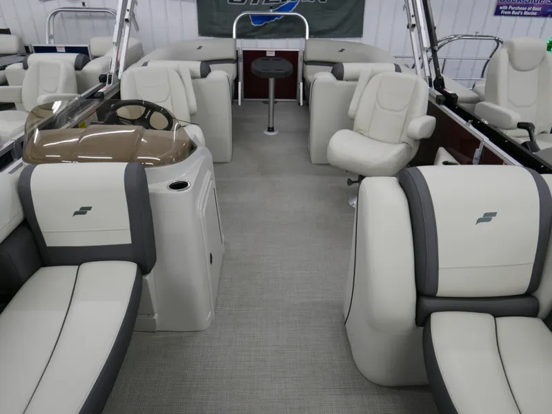 Slide: The Image of 2024 Starcraft EX 22 R pontoon boat interior with plush seating and modern design. - 7