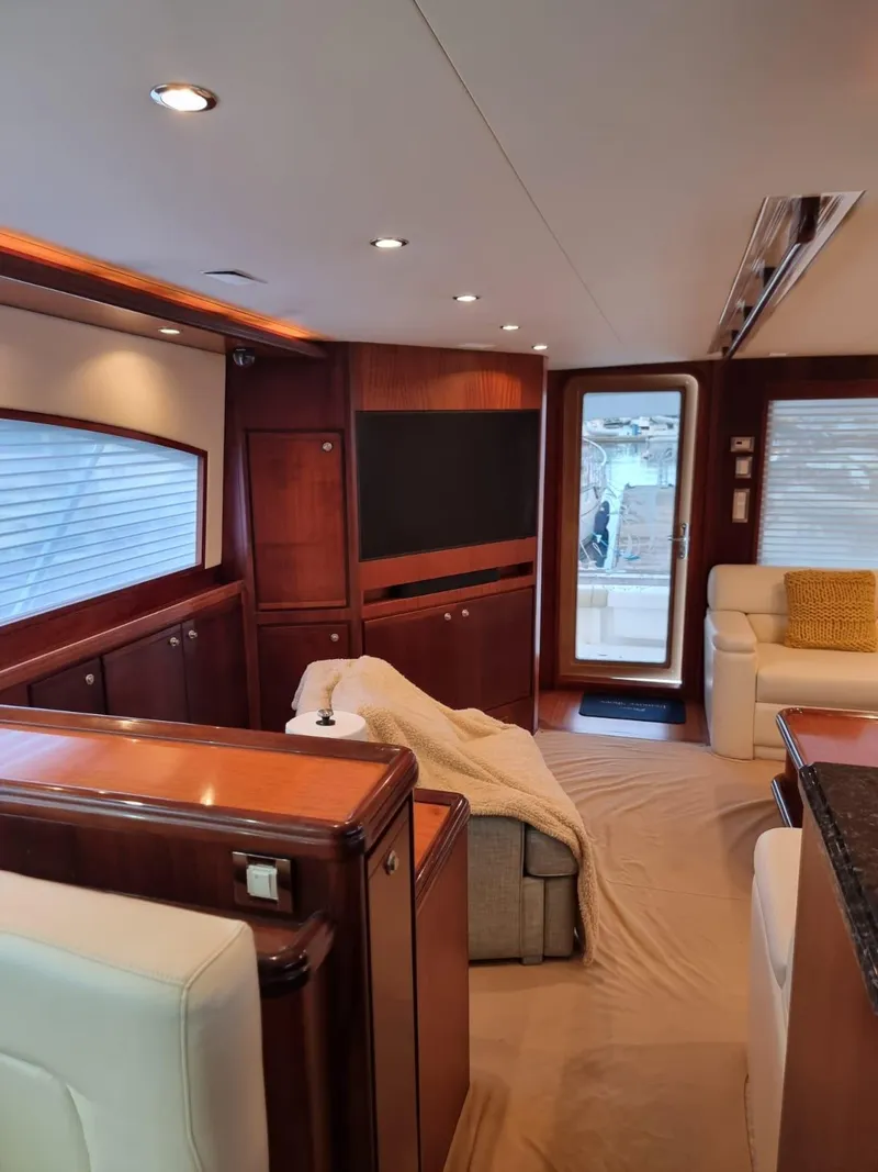 Slide: The Image of Luxurious interior of a 2009 Bertram 700 Enclosed yacht with modern furnishings. - 12