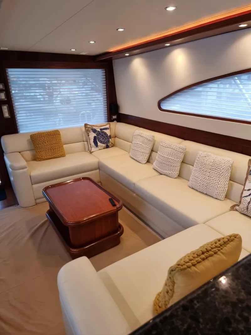 Slide: The Image of Luxurious interior of a 2009 Bertram 700 Enclosed yacht with plush seating. - 13