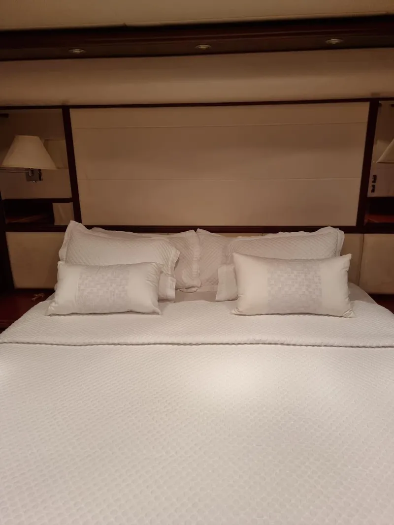 Slide: The Image of Luxurious bedroom in a 2009 Bertram 700 Enclosed yacht with elegant white bedding. - 20