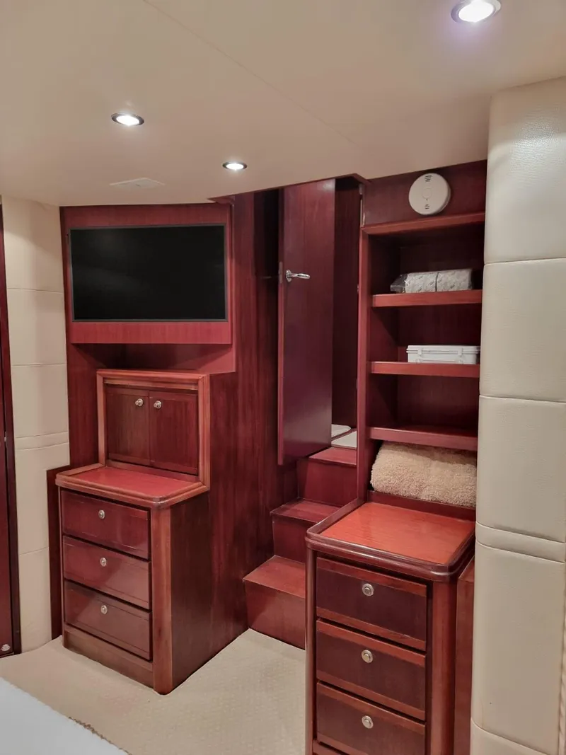 Slide: The Image of Luxurious interior of 2009 Bertram 700 Enclosed yacht with wooden cabinetry and built-in TV. - 21
