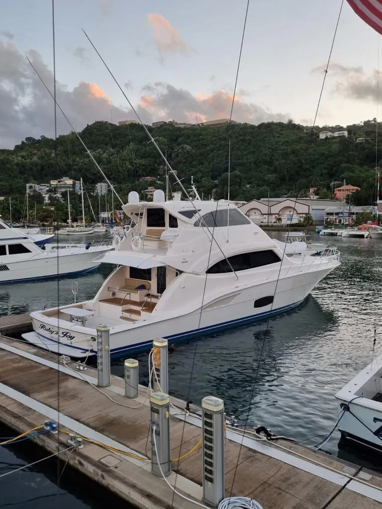 Slide: The Image of 2009 Bertram 700 Enclosed yacht docked at a marina. - 24