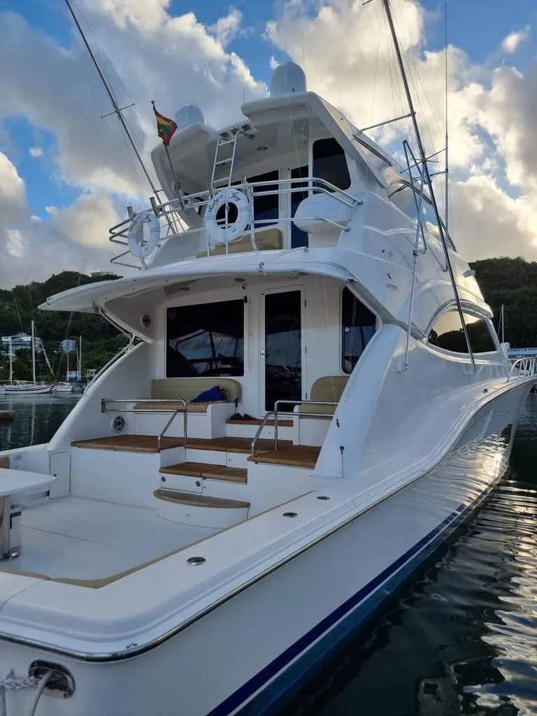 Slide: The Image of 2009 Bertram 700 Enclosed yacht docked at marina with scenic background. - 3