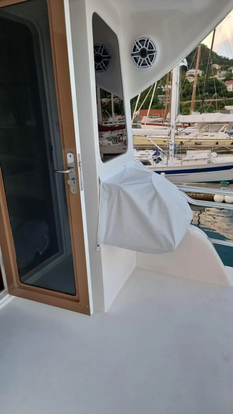 Slide: The Image of 2009 Bertram 700 Enclosed yacht deck with door and covered equipment. - 4