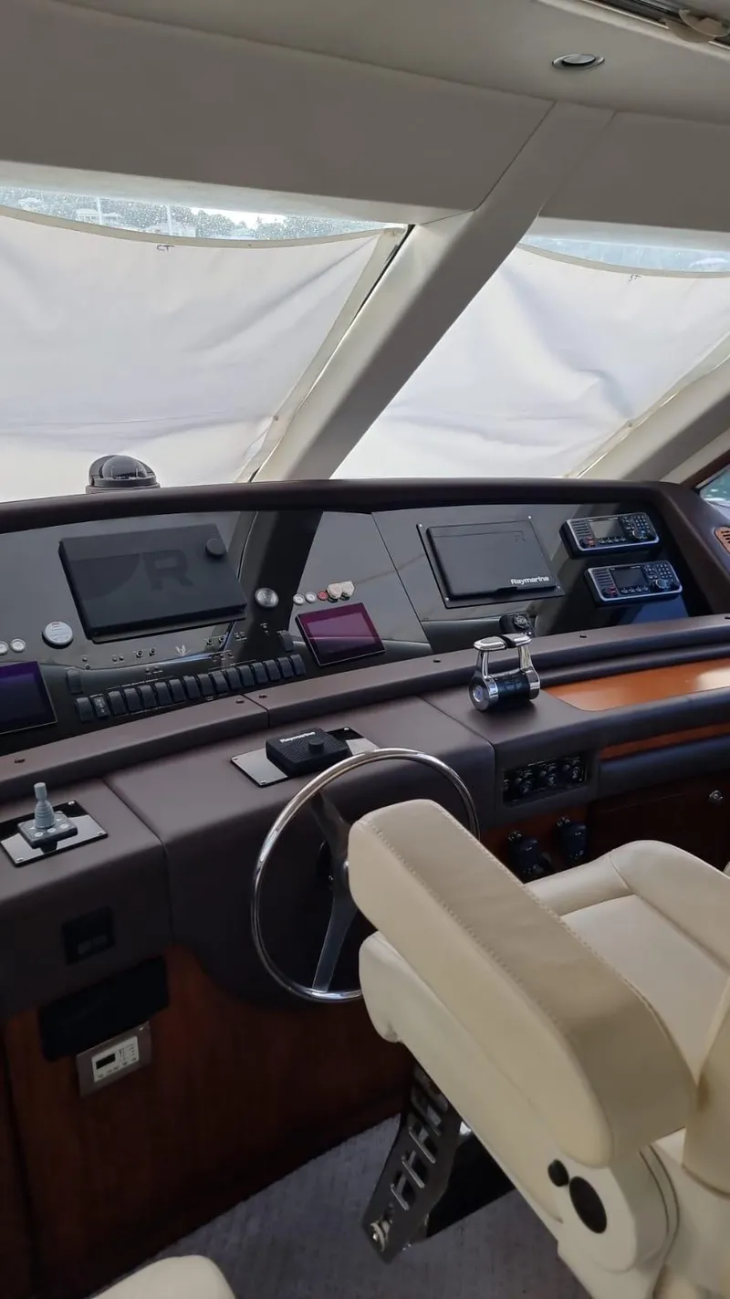Slide: The Image of 2009 Bertram 700 Enclosed yacht helm with advanced navigation systems and luxurious seating. - 7