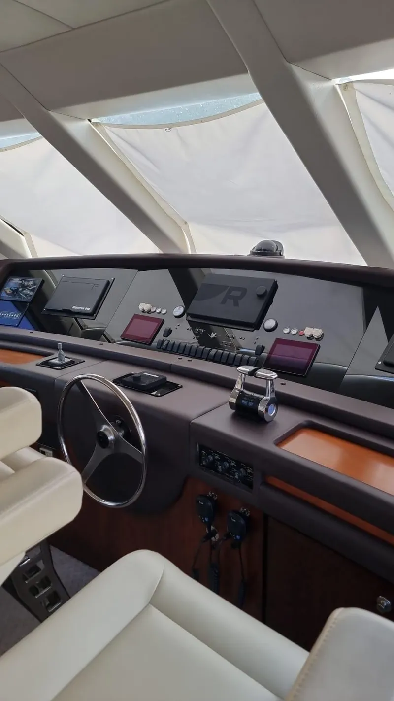 Slide: The Image of Cockpit of a 2009 Bertram 700 Enclosed yacht with modern navigation equipment. - 9
