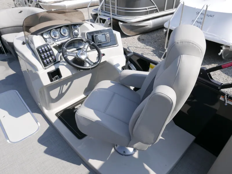 Slide: The Image of 2024 Starcraft SLS 3 Q DH boat cockpit with steering wheel and control panel. - 13