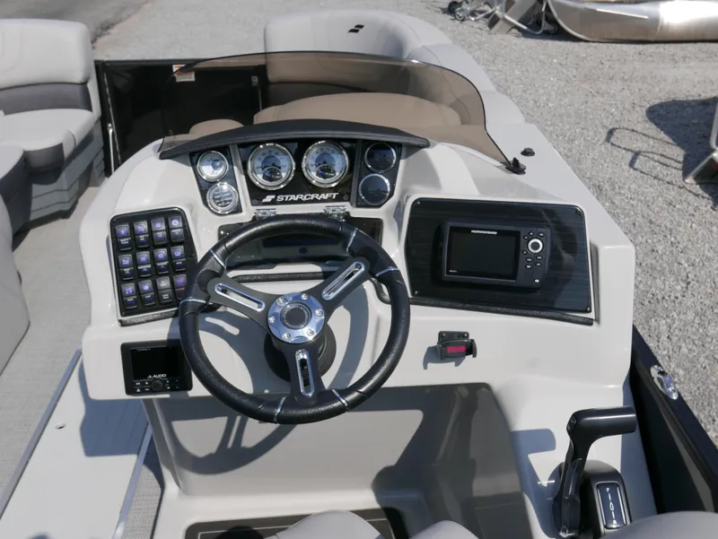Slide: The Image of 2024 Starcraft SLS 3 Q DH boat dashboard with steering wheel and control panel. - 14