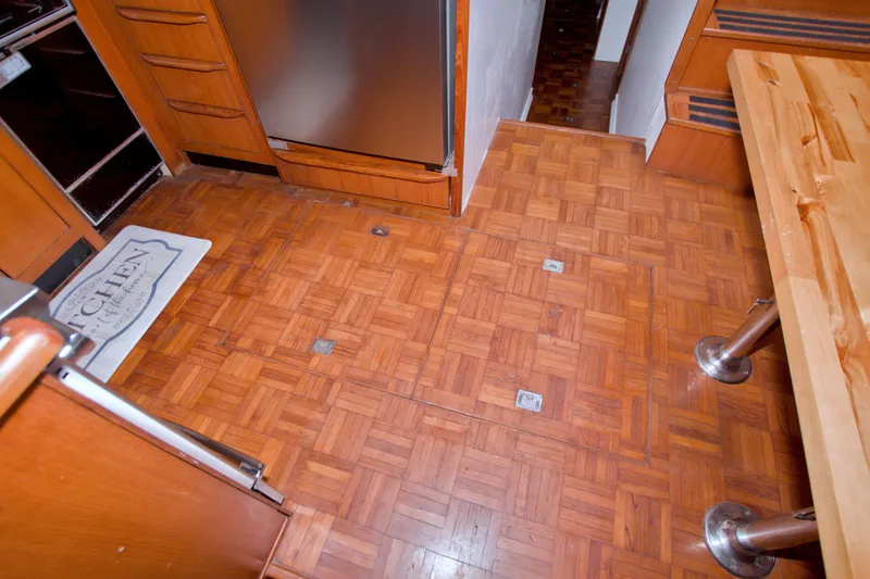 Slide: The Image of 1994 Jefferson Marquessa 56 yacht kitchen with wood flooring and stainless steel appliances. - 120