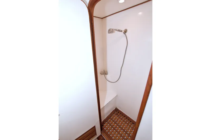 Slide: The Image of Shower area in 1994 Jefferson Marquessa 56 yacht with wooden accents and handheld showerhead. - 81