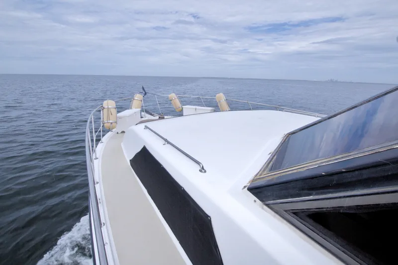 Slide: The Image of 1994 Jefferson Marquessa 56 yacht cruising on open water under cloudy skies. - 43