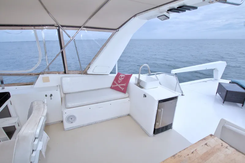 Slide: The Image of Luxurious 1994 Jefferson Marquessa 56 yacht deck with seating, sink, and ocean view. - 18