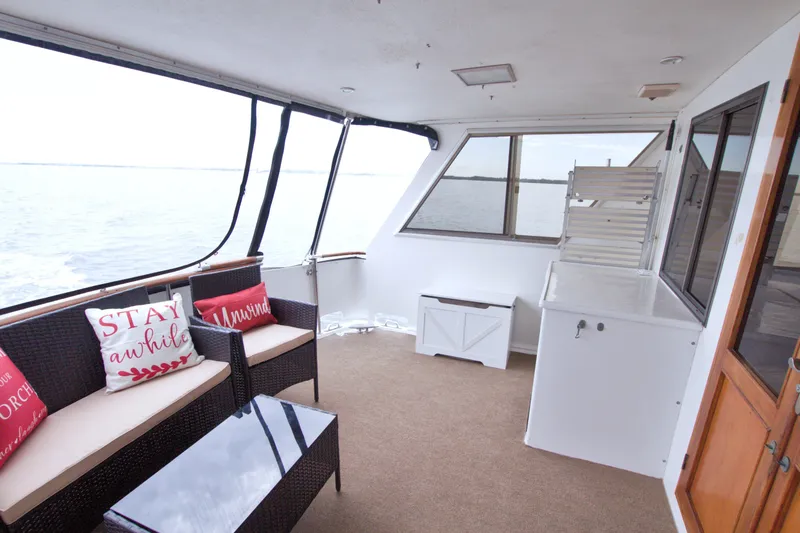 Slide: The Image of 1994 Jefferson Marquessa 56 yacht deck with seating, pillows, and ocean view. - 31