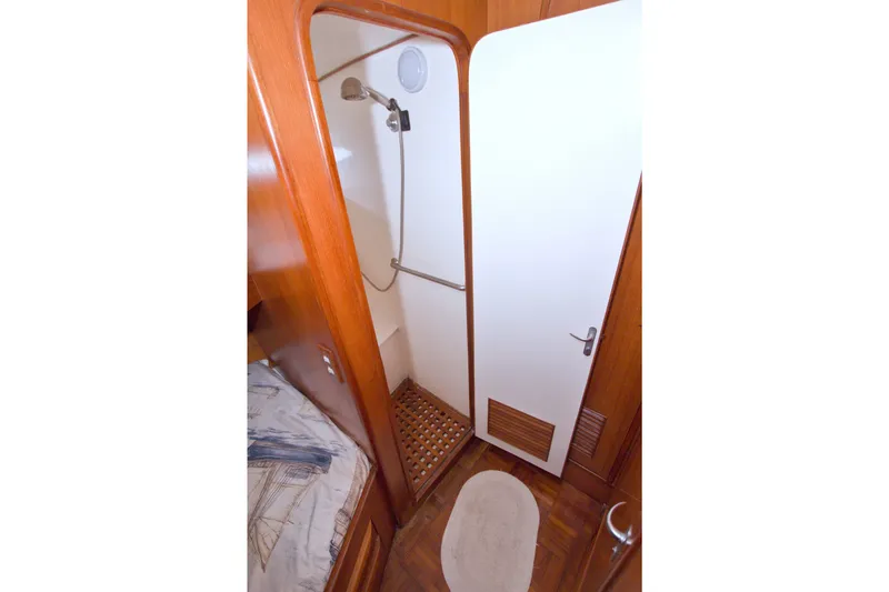Slide: The Image of 1994 Jefferson Marquessa 56 yacht shower with wooden accents and white door. - 68