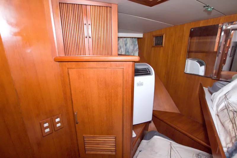 Slide: The Image of 1994 Jefferson Marquessa 56 yacht interior with wooden cabinetry and portable air conditioner. - 64