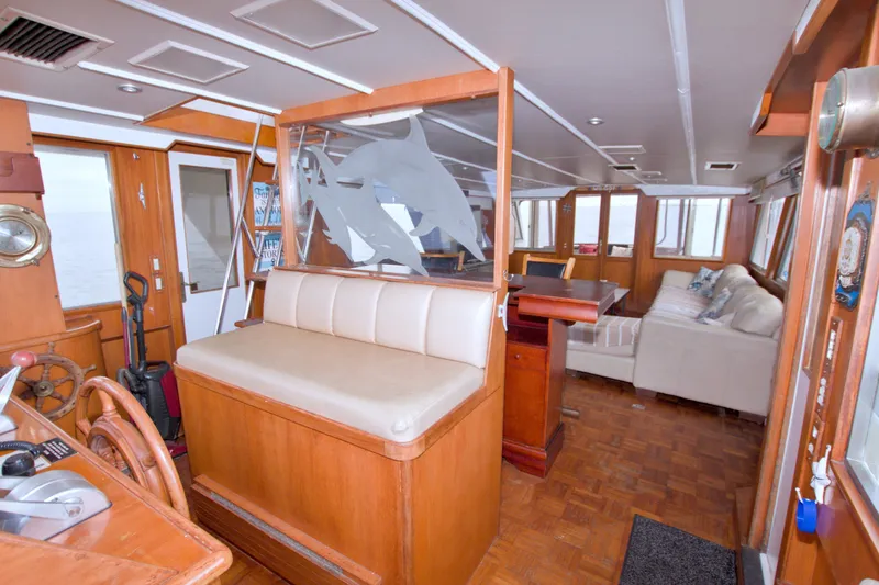 Slide: The Image of Interior of 1994 Jefferson Marquessa 56 yacht with wood paneling and comfortable seating. - 36
