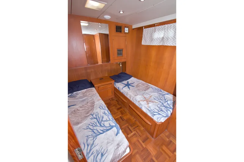 Slide: The Image of Twin cabin with nautical-themed bedding in 1994 Jefferson Marquessa 56 yacht. - 78