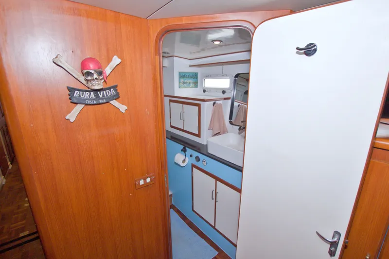 Slide: The Image of Bathroom interior of 1994 Jefferson Marquessa 56 yacht with nautical decor and wooden accents. - 93