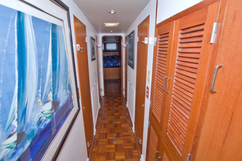 Slide: The Image of Hallway inside 1994 Jefferson Marquessa 56 yacht, featuring wood paneling and nautical artwork. - 84