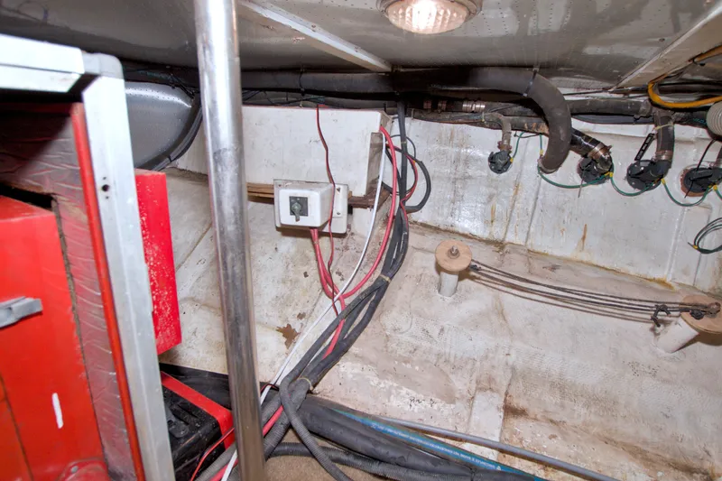 Slide: The Image of Engine room of a 1994 Jefferson Marquessa 56 Extended Deckhouse with wiring and equipment. - 124