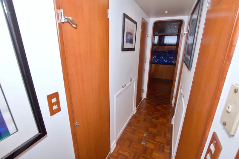 Slide: The Image of Hallway inside 1994 Jefferson Marquessa 56 Extended Deckhouse yacht with wood paneling and framed art. - 86