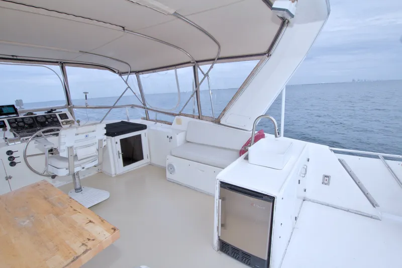 Slide: The Image of 1994 Jefferson Marquessa 56 yacht deckhouse with helm, seating, and ocean view. - 17