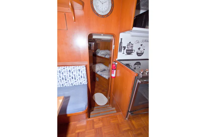 Slide: The Image of Interior of 1994 Jefferson Marquessa 56 yacht with wood paneling and cozy cabin. - 61
