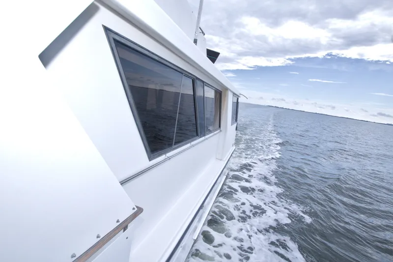 Slide: The Image of 1994 Jefferson Marquessa 56 yacht cruising on open water under a cloudy sky. - 41