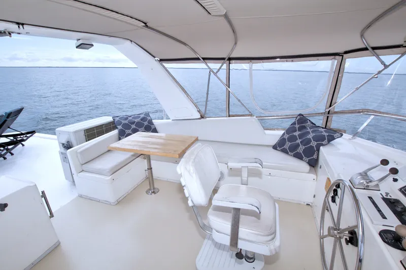 Slide: The Image of Spacious deck of 1994 Jefferson Marquessa 56 yacht with seating and ocean view. - 20