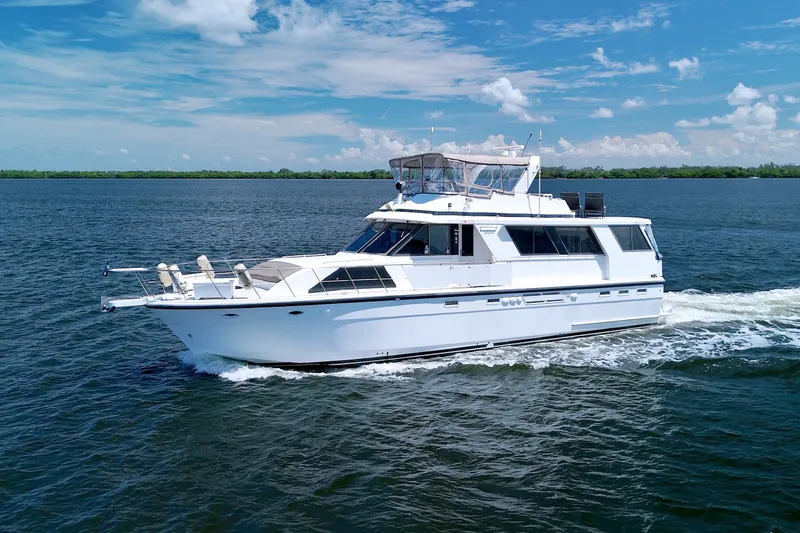 Slide: The Image of 1994 Jefferson Marquessa 56 Extended Deckhouse yacht cruising on open water under blue skies. - 8