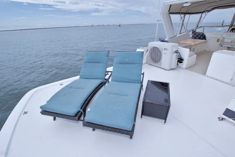Slide: The Image of Deck of 1994 Jefferson Marquessa 56 yacht with lounge chairs and ocean view. - 14